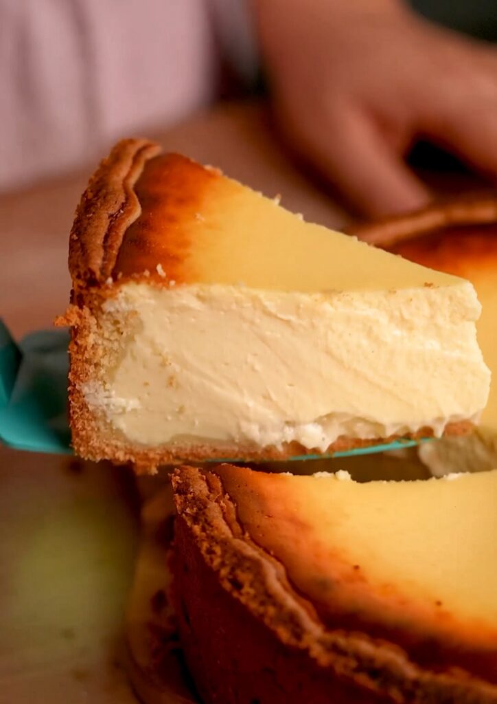 Traditioneller Käsekuchen: Ganze Ansicht eines klassischen Käsekuchens mit goldbrauner Oberfläche, frisch gebacken